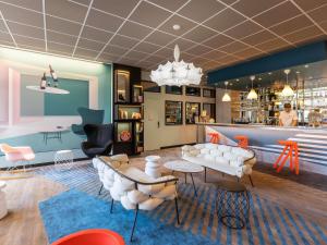 a waiting room with white chairs and a bar at ibis Styles Bordeaux Centre Mériadeck in Bordeaux