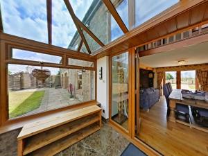 an internal view of a glass house with a living room at The Barn, Luxury Country Home Sleeps 6 Hot Tub Near Durham City & Bishop Auckland in Durham
