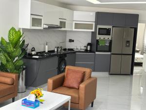 a kitchen with a couch and a chair and a table at Stunning 2 Bedroom Apartment Overlooking the Ocean in Dakar