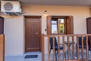 a room with a balcony with a door and a window at Meteora Living Rooms in Kastraki