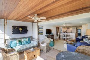 a living room with blue furniture and a ceiling at Beach Club Villa 30 - Coastal Oceanfront! Pool! Walkout! in Isle of Palms