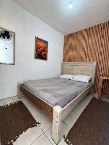 a bedroom with a large bed in a room at Pousada Mãe Linda in Aparecida +55 photos