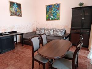 a living room with a table and a couch at Aparthotel NA DOBU in Lviv