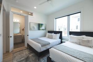 a bedroom with two beds and a window at Broadway Breakaway I Rooftop HotTub in Nashville