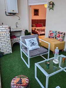 Una sala de estar con un sofá, una silla y una mesa. en Hammamet appart with pool, en Nabeul