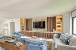 a living room with a couch and a table at 4 Mi to Lovers Key SP Modern Condo with Ocean Views in Fort Myers Beach