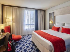 a hotel room with a large bed and a window at Mercure Chartres Centre Cathedrale in Chartres +57 photos