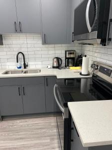 a kitchen with a sink and a counter top at The Willow Nest lower suite-2 Rooms in Calgary +6 photos