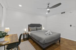 a bedroom with a bed with a ceiling fan at SOCO Downtown View I Free Pkg in Austin