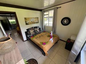 a bedroom with a bed with a monkey on it at Vainoa house in Tikehau