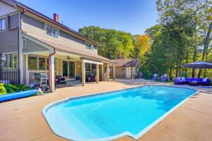 a swimming pool in front of a house at 1 Mi to Okemo Mtn Resort Ludlow Home with Hot Tub in Ludlow