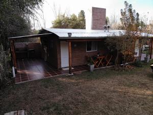 a house with a dog sitting on top of it at Cabañas Las Rositas in Villa de Las Rosas