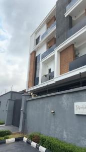 a building with a sign in front of it at The Ivory Luxe Suit Lekki phase 1 Lagos in Lagos