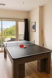 a ping pong table in a living room with at Family Group Retreat 3 Queens Pool Table 2nd in Homewood