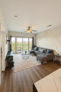 a living room with a couch and a table at Across from UAB Spacious 2BR Retreat 5th in Homewood