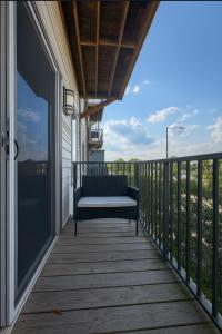 a porch with a bench on a balcony at Across from UAB Spacious 2BR Retreat 2nd in Homewood