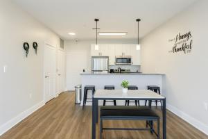 a kitchen and dining room with a table and chairs at Across from UAB Spacious 2BR Retreat 3a in Birmingham