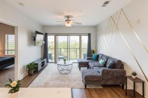 a living room with a couch and a table at Across from UAB Spacious 2BR Retreat 3a in Homewood