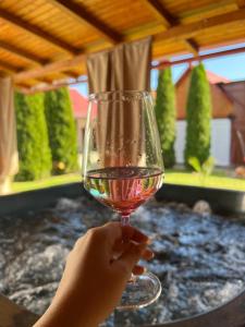 a person holding a glass of wine on a table at B&B House 