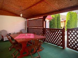a wooden table and chairs on a wooden deck at B&B House in Obreja