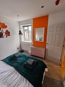 a bedroom with a bed with two towels on it at Cardiff central in Cardiff