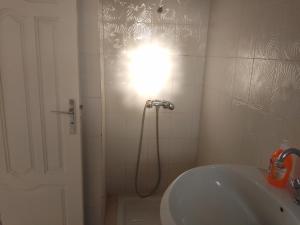 a bathroom with a shower with a light on the wall at Jamila 3 in Midoun +4 photos