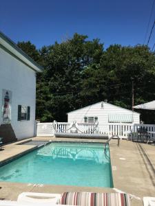 a swimming pool in front of a house at Crosswinds Motel in Old Orchard Beach