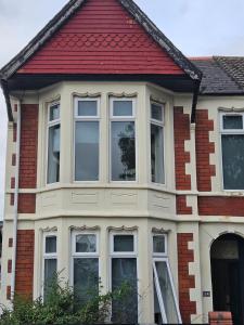 a house with a red roof and many windows at Cardiff central in Cardiff
