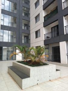 a large building with palm trees in front of it at Casa Liora Studio by UN & Two Rivers in Nairobi