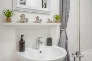 a bathroom sink with a soap dispenser on it at Elmsleigh Nest in Rothbury +16 photos