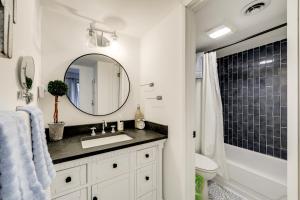 a bathroom with a sink and a mirror at Sevierville Condo with Balcony and Pool Access! in Sevierville