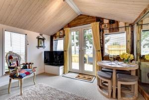 a living room with a table and a tv at 1 Bed in Totnes oc-bc1000 in Totnes