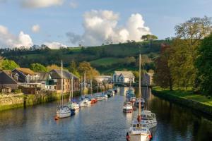a group of boats docked in a river with houses at 1 Bed in Totnes oc-bc1000 in Totnes +4 photos