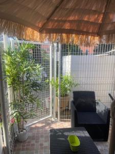a screened in porch with a couch and a table at Studio Jeanine in Le Portel