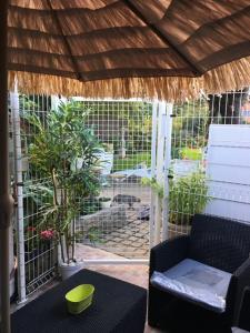 a screened in porch with a couch and a table at Studio Jeanine in Le Portel +12 photos