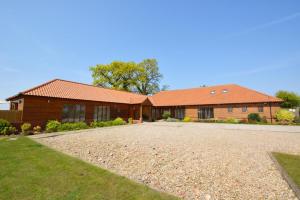 a house with a gravel driveway in front of it at Skipjack Field View in Ingworth
