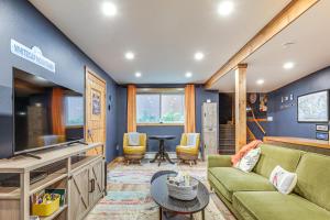 a living room with a couch and a tv at Ski-InandSki-Out Condo in Upson - Walk to Lake in Upson