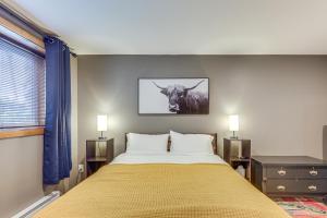 a bedroom with a bed with a cow on the wall at Ski-InandSki-Out Condo in Upson - Walk to Lake in Upson +25 photos