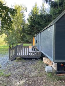 a train car is parked next to a house at Maringotka u lesa in Staňkovice +9 photos