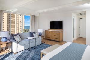 a hotel room with a bed and a television at Jupiter Beach Resort & Spa in Jupiter