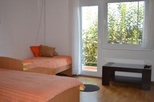 a room with two beds and a window at Apartments Ballabanka in Koper