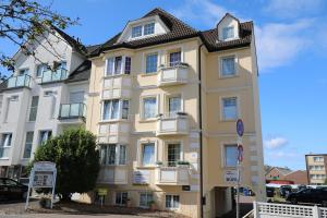 a large yellow building with a black roof at Nordsee 03 in Cuxhaven +4 photos