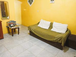 a bedroom with a bed with two pillows and a table at Próximo ao Hangar - COP30 in Belém