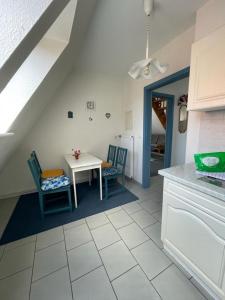 a kitchen with a table and chairs in a room at Haus Nordseegruß 2 in Cuxhaven
