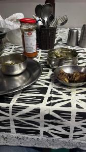a black and white table with plates of food on it at Raj Kot in Nainital