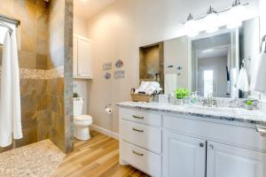a bathroom with a sink and a toilet and a shower at Luxe Waterfront Home with Boat Slip in New Braunfels in Schumannsville +28 photos