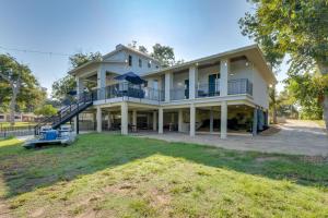a large house with a staircase in front of it at Luxe Waterfront Home with Boat Slip in New Braunfels in Schumannsville