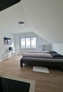 a bedroom with a large bed and a table at Casa Maria Bern in Bern