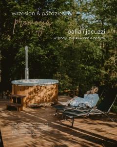 a woman laying in a hammock next to a tub at Malinova 36 in Wisła