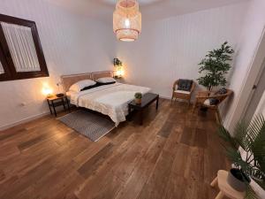 a bedroom with a bed and a table and chairs at Finca Jardín del Norte in Gáldar